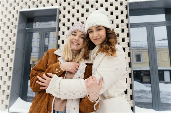 Young girlfriends outdoor hugging 4