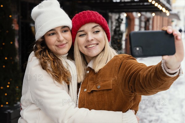 Young girlfriends taking selfie