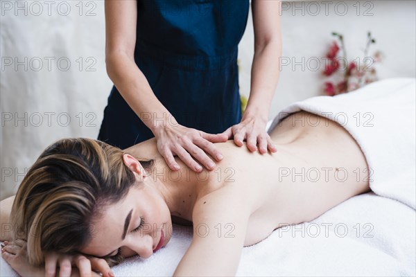 Relaxed woman enjoying back massage