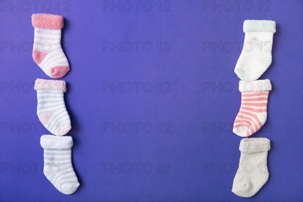 Row many baby s socks blue background