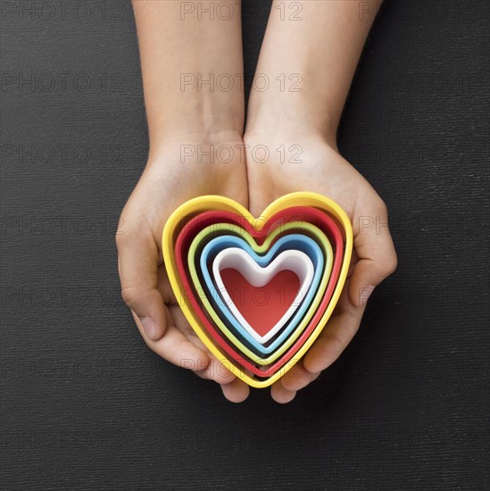 Top view hands holding elements shape hearts