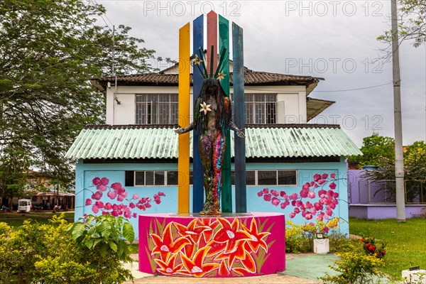 Sculpture in front of house with graphite on the wall