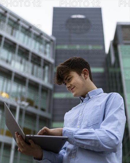 Medium shot boy holding laptop