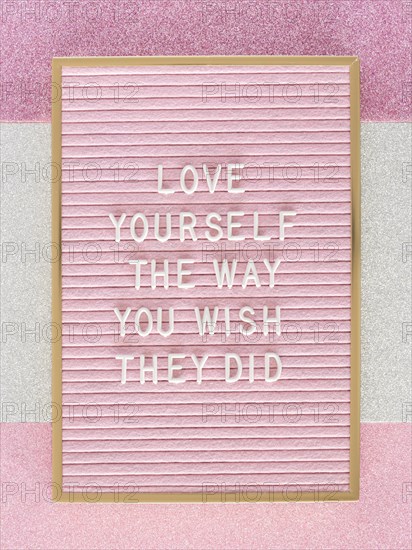Pink motivational text board top view