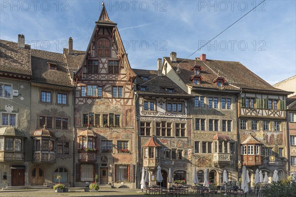 Medieval houses with facade paintings on the Rathausplatz in the old town centre
