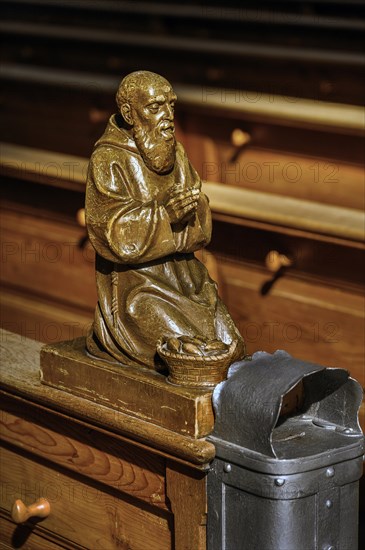 Praying figure on a church bench