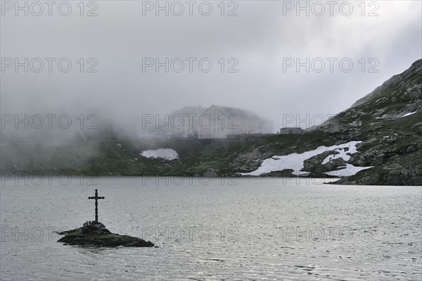 Mist over lake and hospice for travellers