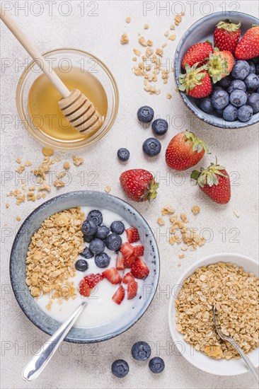 Top view breakfast bowl with honey fruits