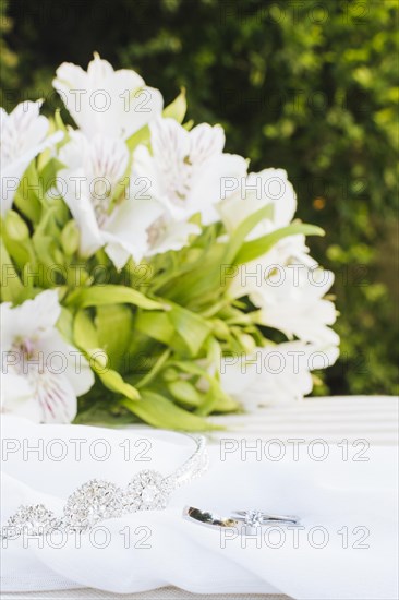 Two wedding rings crown scarf with beautiful flower bouquet table