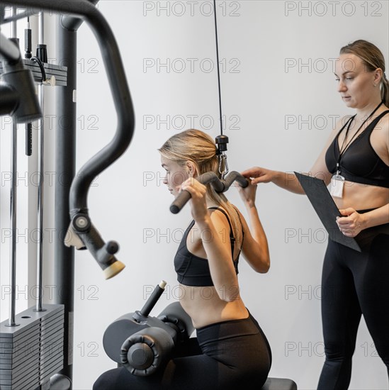 Young woman exercising gym side view