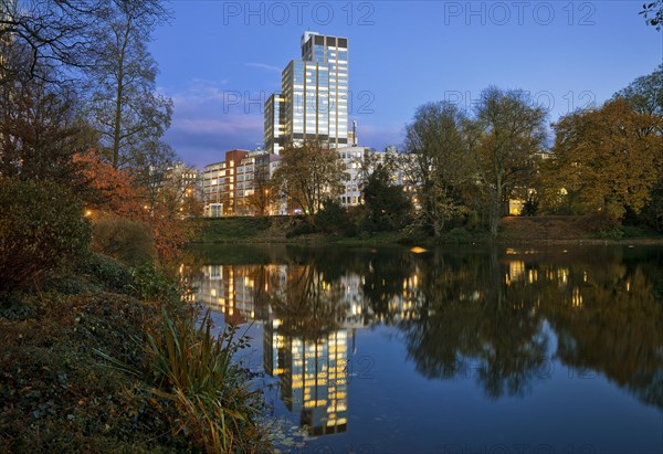 The LVA main building reflected in the Kaiserteich in autumn in the evening