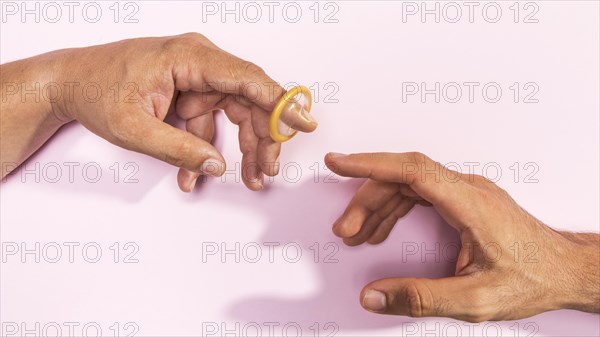 Close up man hands with transparent condom