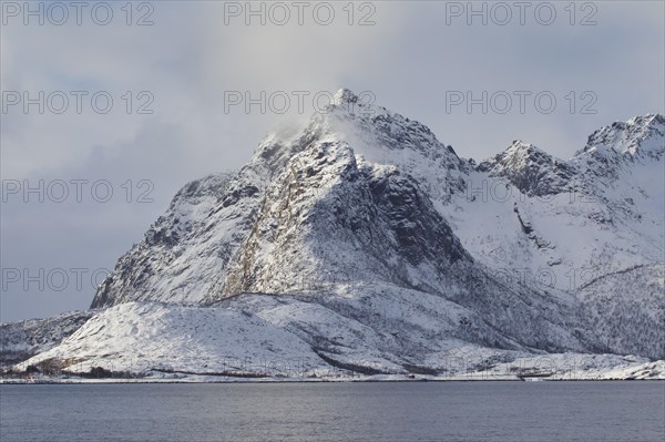 Snow covered mountains along the fjord Raftsund in winter