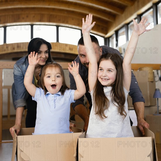 Medium shot parents kids with boxes