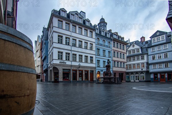 Reflection in a puddle between a historic city centre. Cityscape at the Roemer and the historic houses and streets. Cityscape in Frankfurt am Main