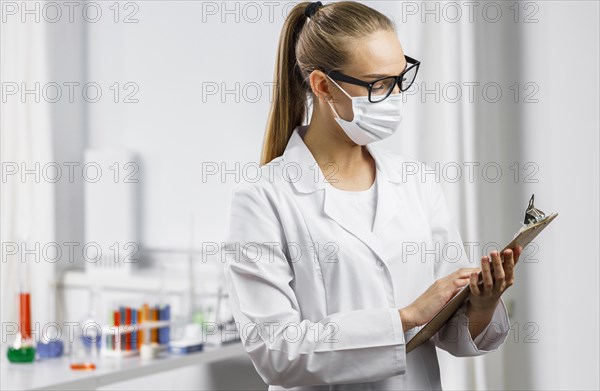 Portrait female researcher with medical mask clipboard