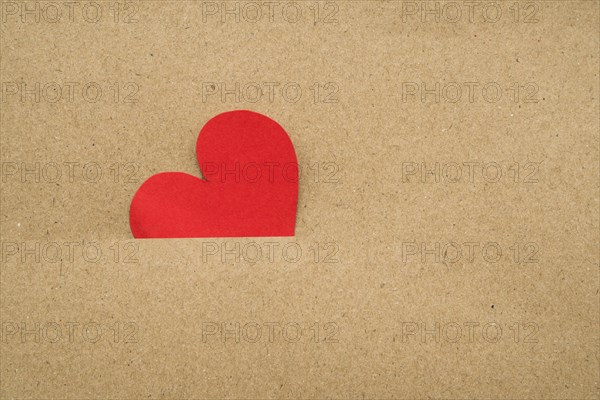 Red heart inside cardboard