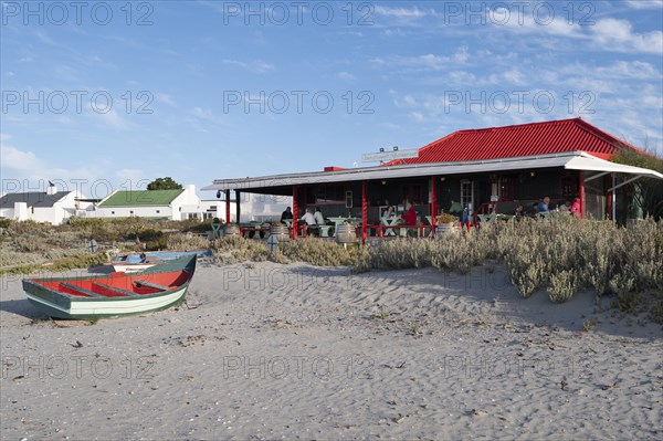 Fishing boat in front of beach restaurant
