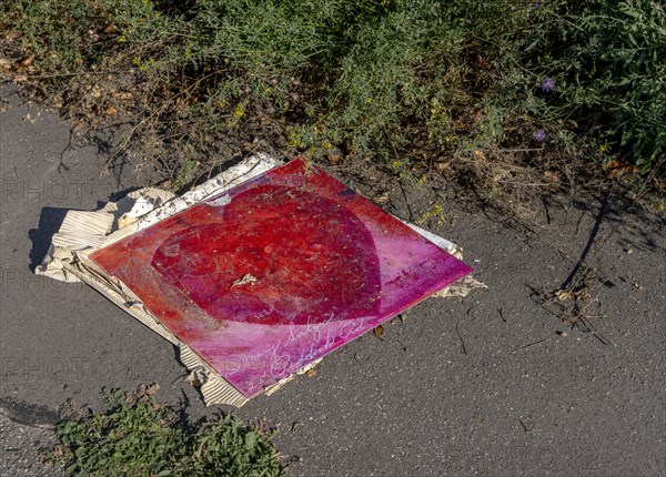 Poster with red heart on the pavement