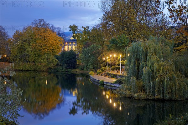 The Staendehaus K21 is reflected in the Kaiserteich in autumn in the evening