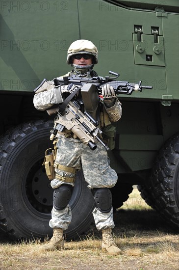 Army enthousiast wearing desert camouflage combat uniform during open day of the Belgian army at Leopoldsburg