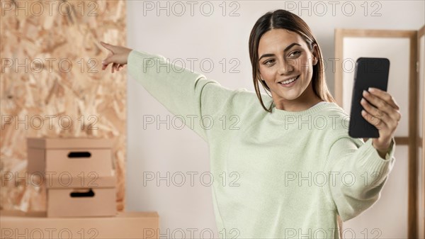 Medium shot woman taking selfie