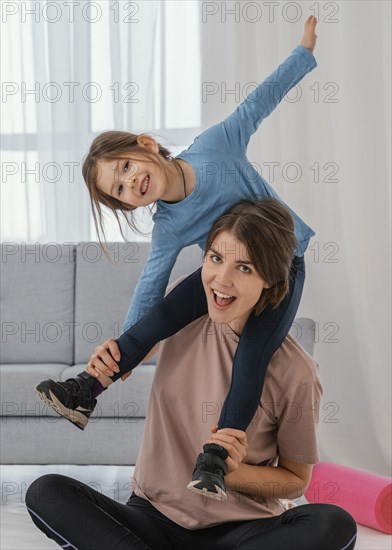 Mother holding girl shoulders medium shot