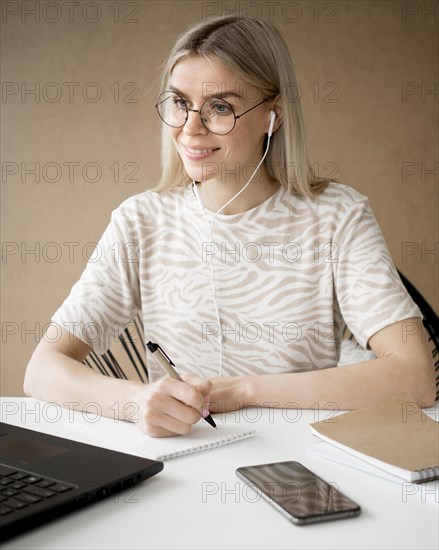 Woman taking notes smiles