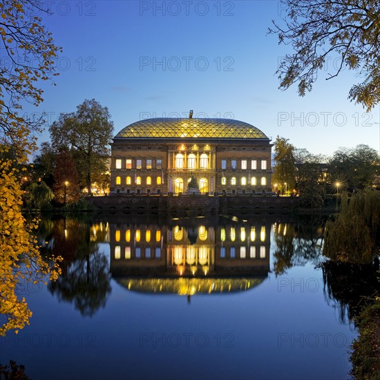 The Staendehaus K21 is reflected in the Kaiserteich in autumn in the evening