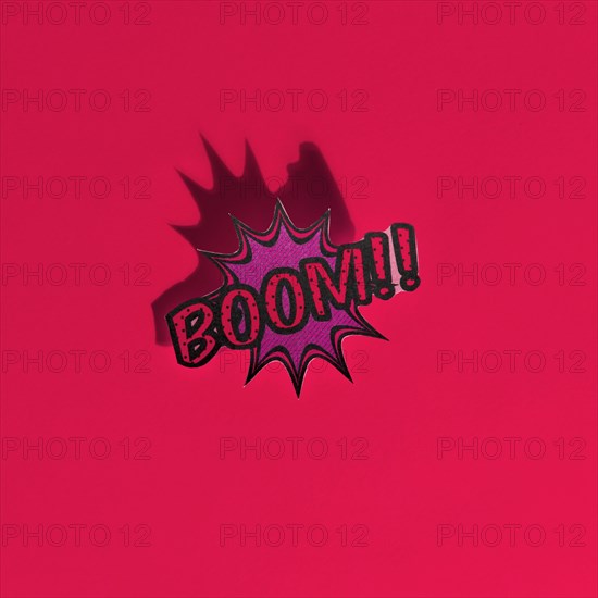 Boom comic text speech bubble pop art style sound effect red backdrop