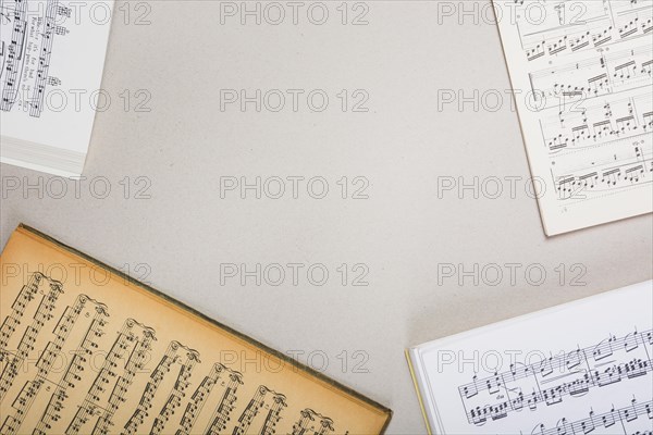 Overhead view musical note books white background with space text