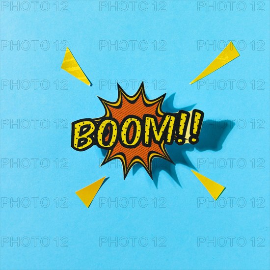 Pop art comics boom speech bubble against blue backdrop