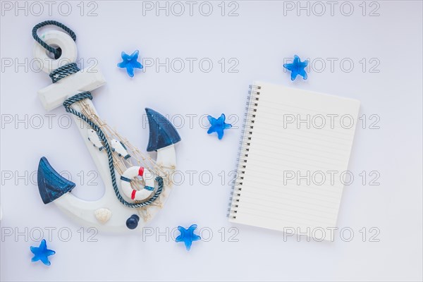 Small wooden anchor with blank notebook