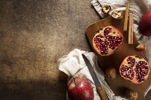 Top view autumn pomegranates with copy space cinnamon sticks