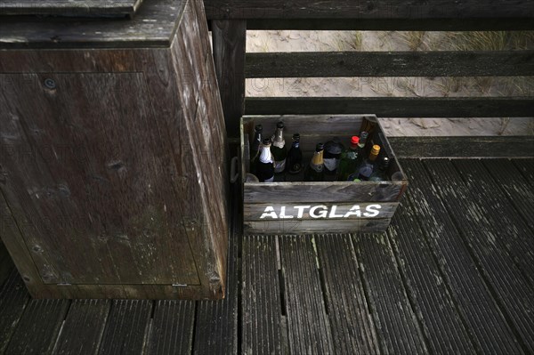 Empty champagne bottles in crate for disposal of waste glass