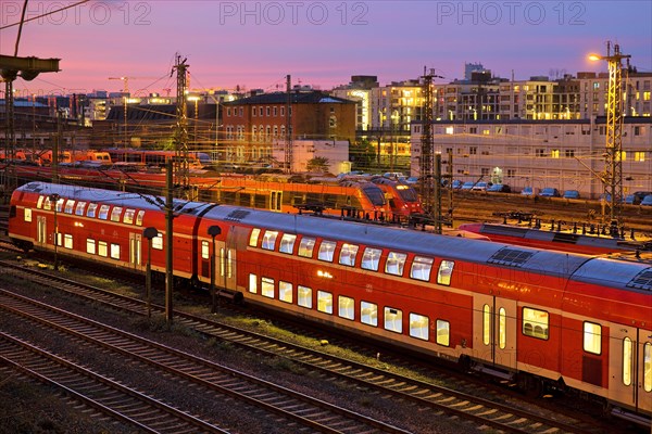 Elevated view of a double-decker commuter train at sunset