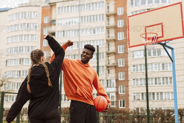 Teenager playing basketball together