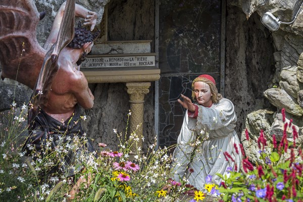 Sculpture of the devil and St Anthony of Padua at grotto in the village Crupet