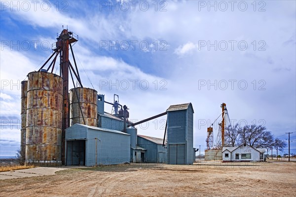 Silos connected to a grain elevator on a farm near the village Melrose in Curry County