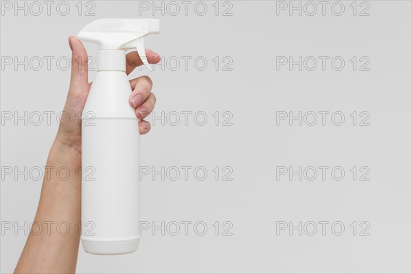 Hand holding disinfectant bottle with copy space