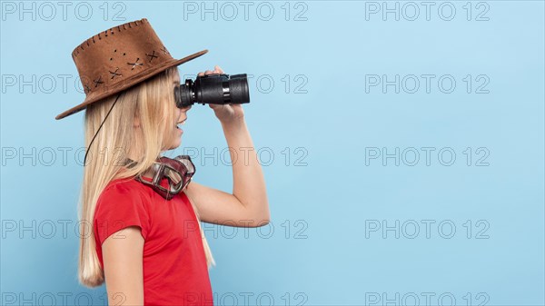 Side view girl looking with binocular