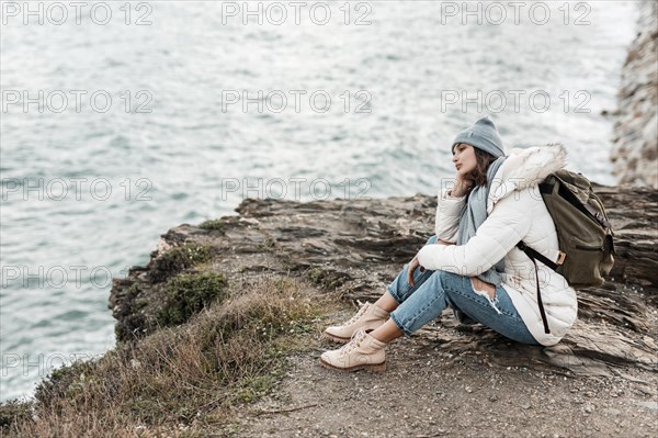 Side view woman enjoying beach view alone