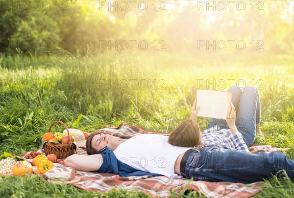 Woman leaning boyfriend reading book