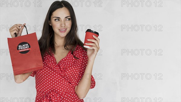 Young woman holding black friday shopping bag