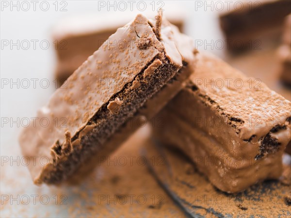 Staked pieces brownies with cocoa powder