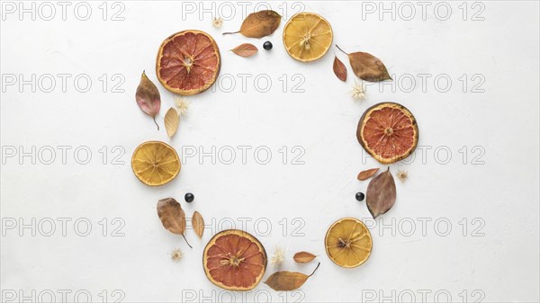 Top view autumn leaves with dried citrus