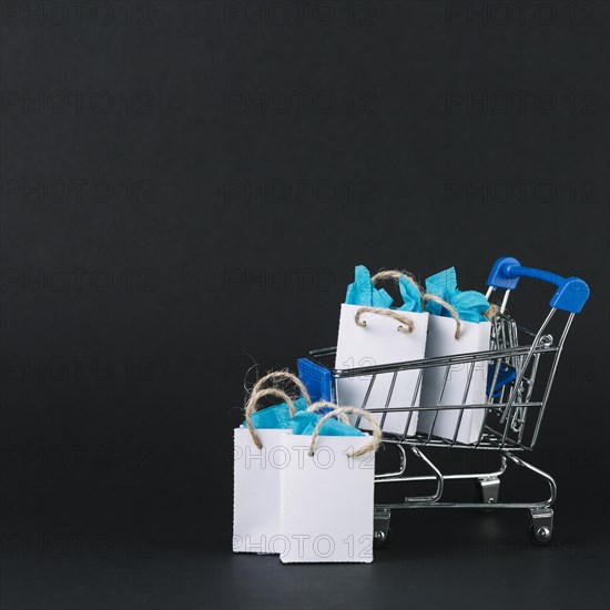 Toy shopping trolley with gifts packets