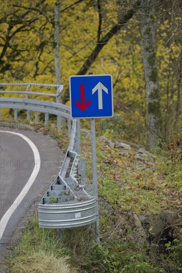 Signs with traffic rules to give way on bridge with narrow road width