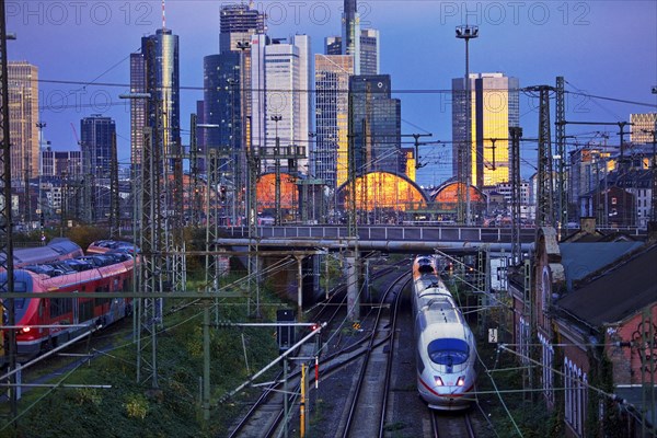 Elevated city view with trains to the main railway station with skyscrapers at dusk