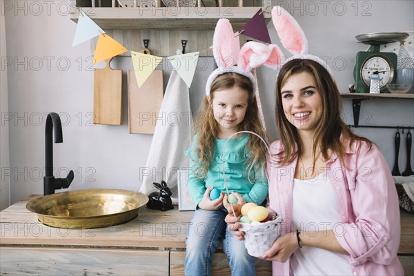 Young woman daughter standing with basket easter eggs